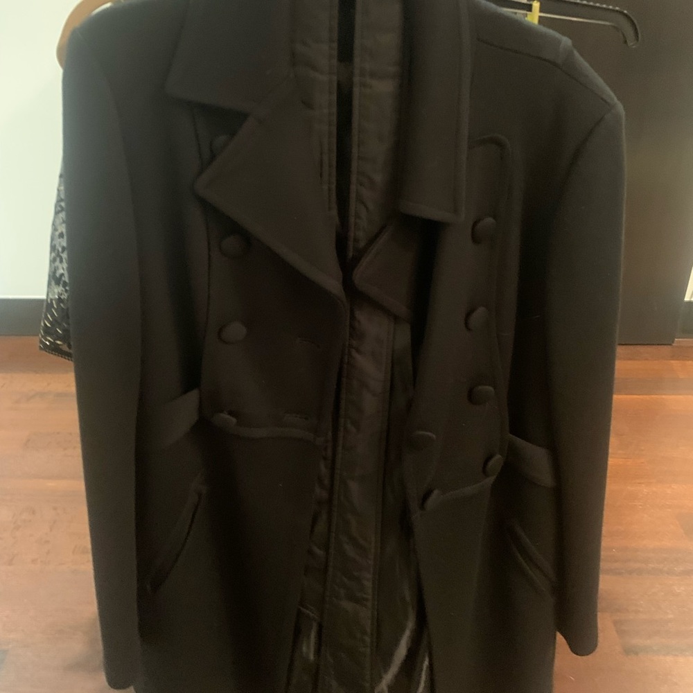 Black heavy winter coat. Just above the knee and has a clasp around the stomach